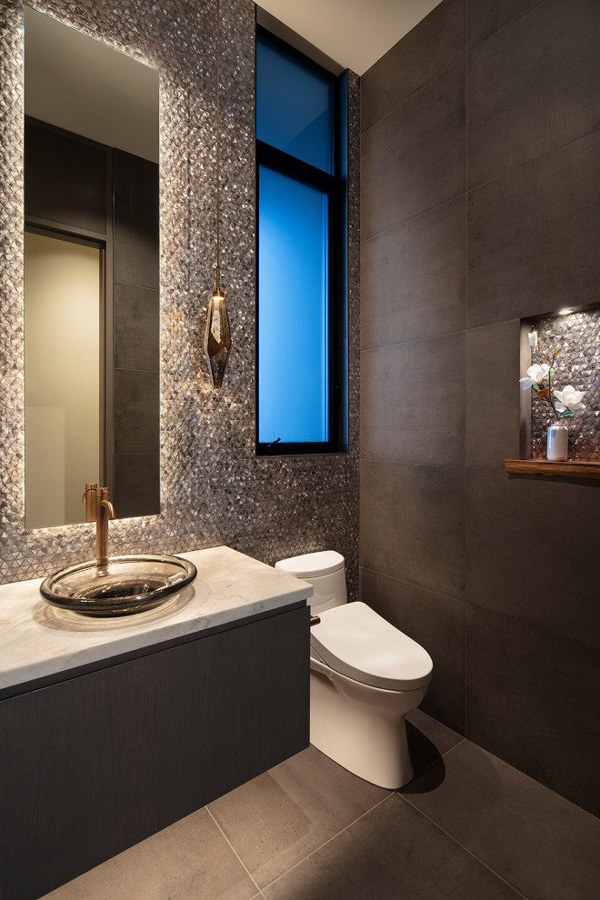 Photo of a small contemporary cloakroom in San Francisco with flat-panel cabinets, dark wood cabinets, a bidet, grey tiles, metal tiles, grey walls, porcelain flooring, a vessel sink, marble worktops, grey floors, white worktops and a built in vanity unit.