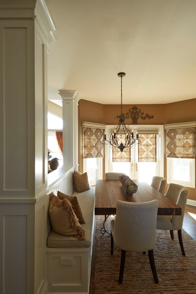 Eat-in kitchen - mid-sized transitional u-shaped medium tone wood floor eat-in kitchen idea in Tampa with a farmhouse sink, white cabinets, quartzite countertops, beige backsplash, ceramic backsplash, paneled appliances and an island