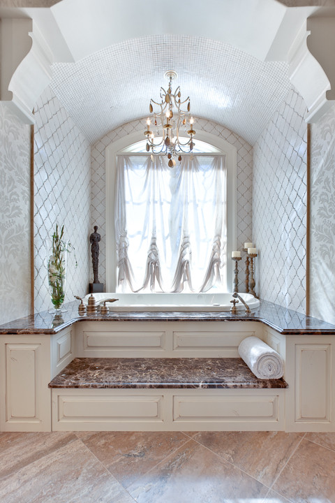 This is an example of an expansive traditional bathroom in Atlanta with an undermount sink, furniture-like cabinets, medium wood cabinets, granite benchtops, a drop-in tub, brown tile, stone tile, beige walls and travertine floors.