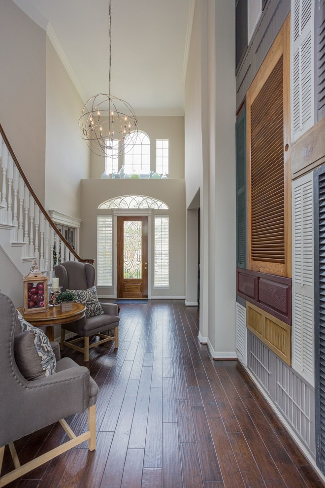 This is an example of a mid-sized transitional foyer in Tampa with grey walls, dark hardwood floors, a single front door, a metal front door and brown floor.