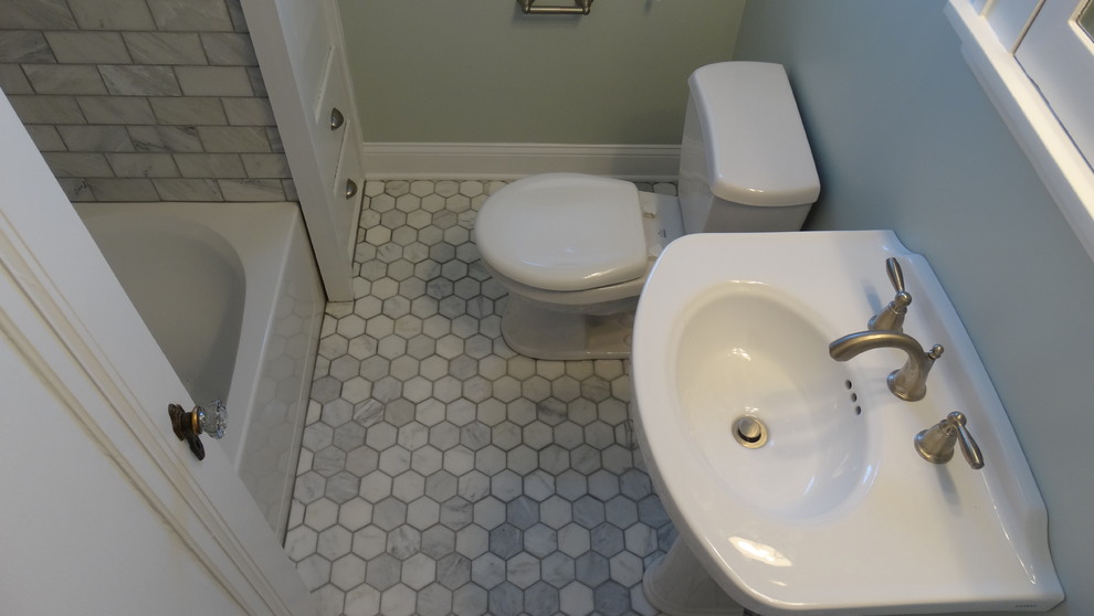 This is an example of a small modern 3/4 bathroom in Cleveland with a pedestal sink, an alcove tub, a shower/bathtub combo, gray tile, subway tile and marble floors.