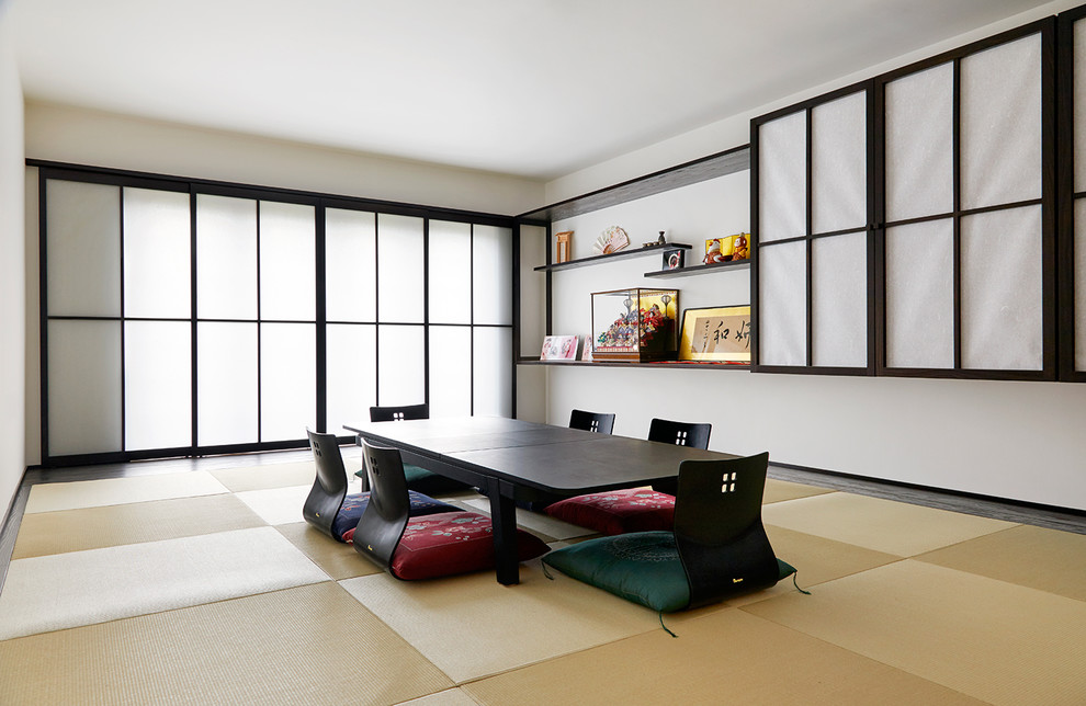 This is an example of an asian separate dining room in Buckinghamshire with white walls, tatami floors, no fireplace and beige floor.