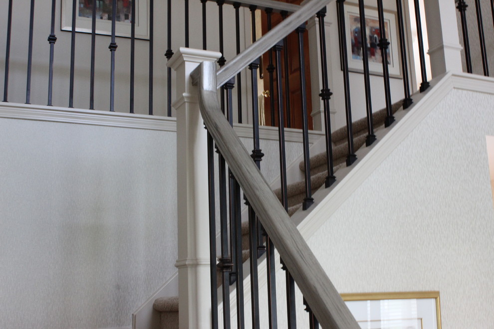 Example of a transitional carpeted foyer design in New York with gray walls