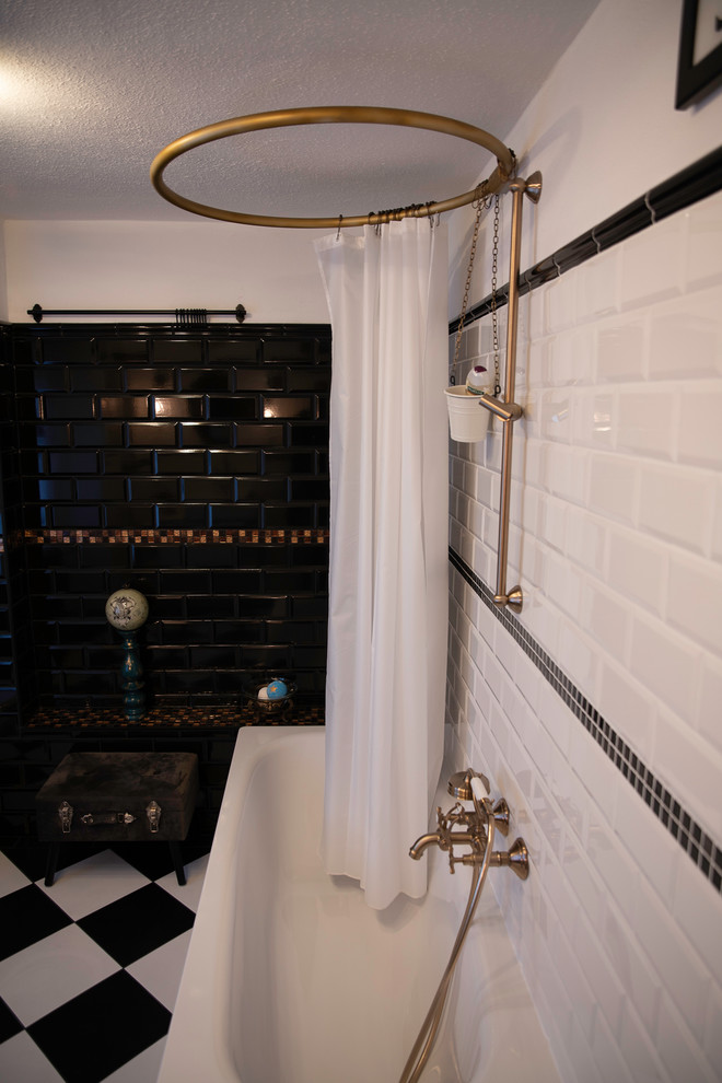 Inspiration for a mid-sized industrial 3/4 bathroom in Other with glass-front cabinets, white cabinets, an undermount tub, a two-piece toilet, black and white tile, subway tile, white walls, ceramic floors, a vessel sink, stainless steel benchtops, black floor, a shower curtain and white benchtops.