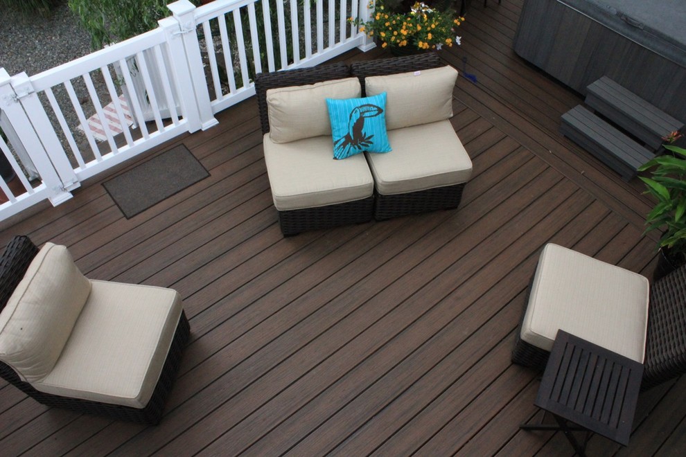 Photo of a mid-sized beach style backyard deck in Philadelphia with a pergola.