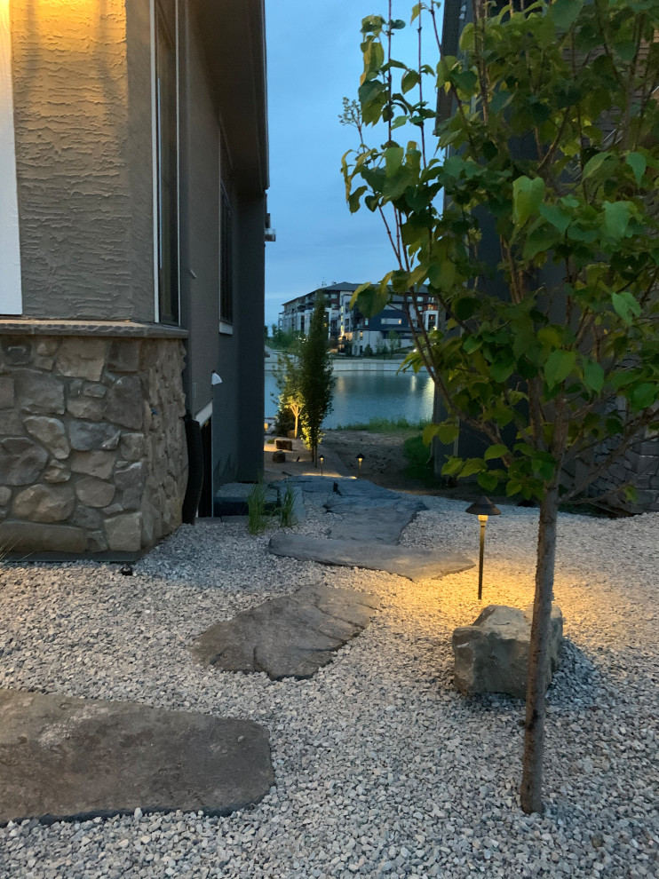 Photo of a large beach style side yard full sun xeriscape in Calgary with with path and decomposed granite.