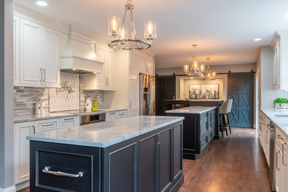 Example of a large transitional kitchen design in Boston with two islands