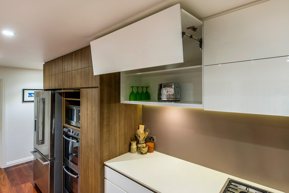 Design ideas for a large contemporary galley eat-in kitchen in Perth with an undermount sink, flat-panel cabinets, white cabinets, quartz benchtops, brown splashback, porcelain splashback, stainless steel appliances, dark hardwood floors and with island.