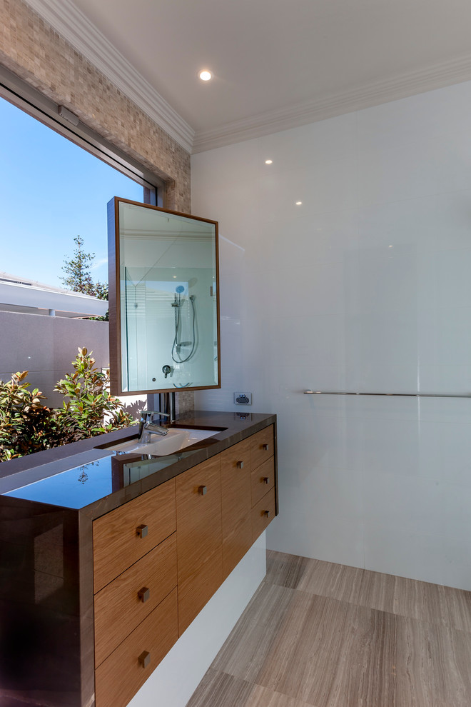 Inspiration for a large contemporary bathroom in Perth with an undermount sink, furniture-like cabinets, medium wood cabinets, engineered quartz benchtops, white tile, porcelain tile and porcelain floors.