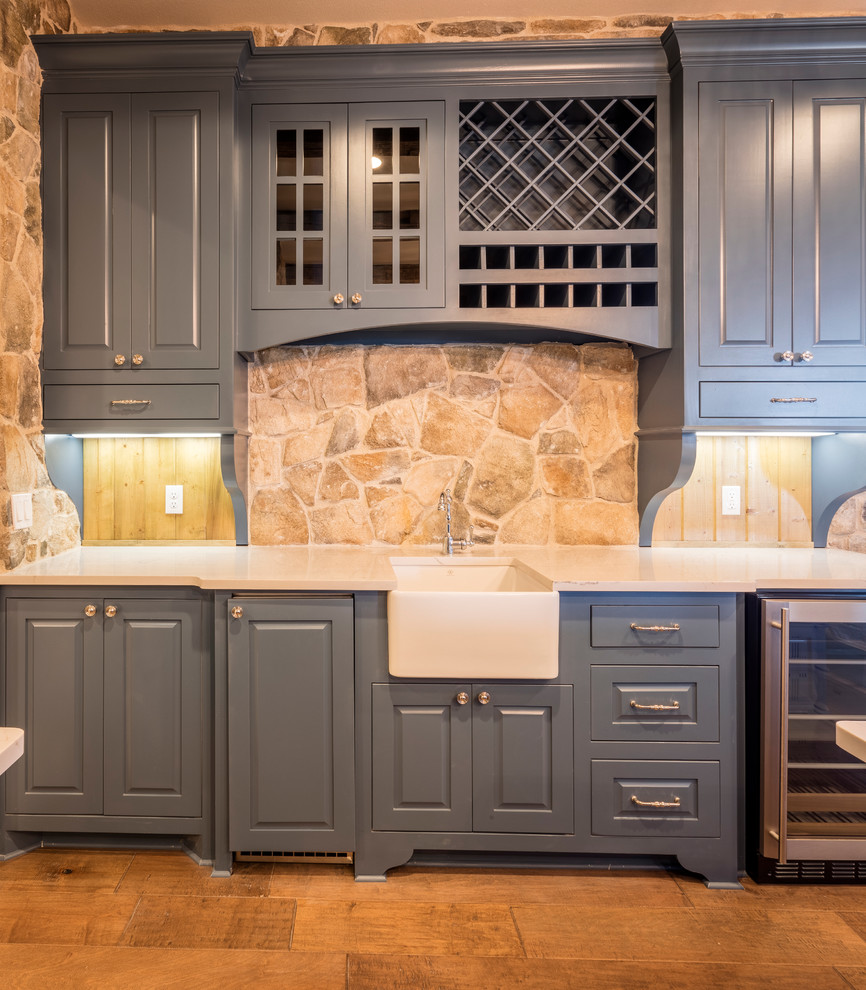 Large mountain style u-shaped medium tone wood floor eat-in kitchen photo in Austin with a farmhouse sink, shaker cabinets, blue cabinets, granite countertops, multicolored backsplash, stainless steel appliances and an island