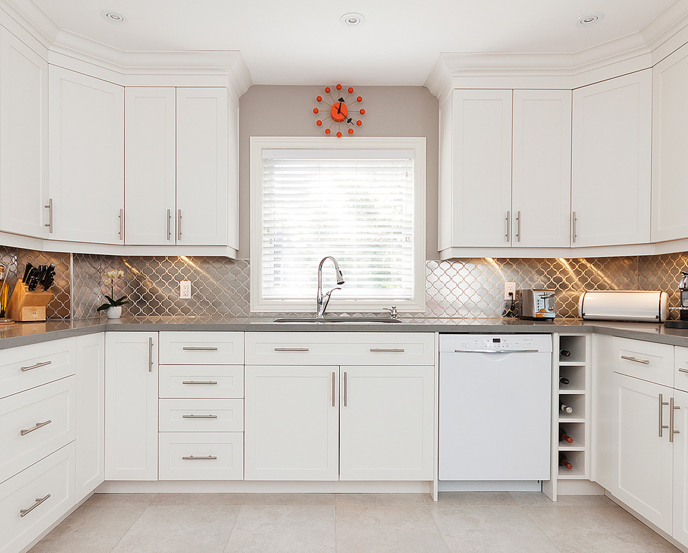 Example of a transitional u-shaped kitchen design in Toronto with shaker cabinets, white cabinets, metallic backsplash, metal backsplash, no island and white appliances