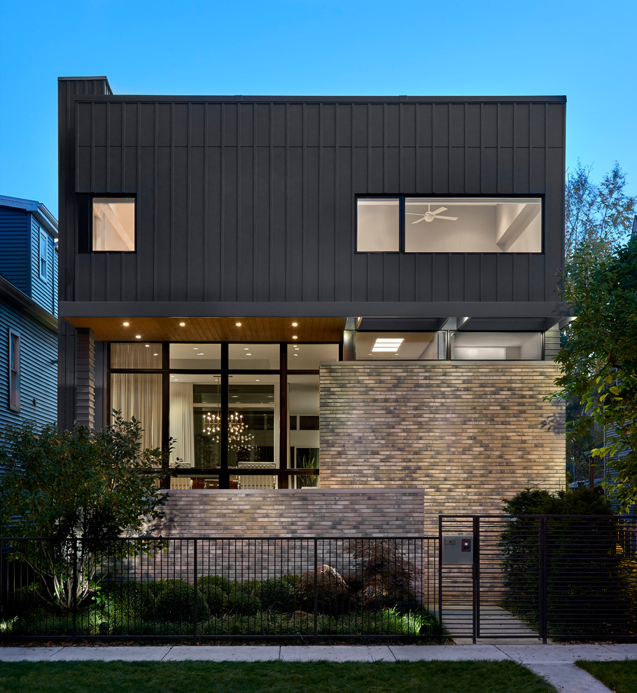 Design ideas for a mid-sized contemporary two-storey grey exterior in Chicago with concrete fiberboard siding and a flat roof.