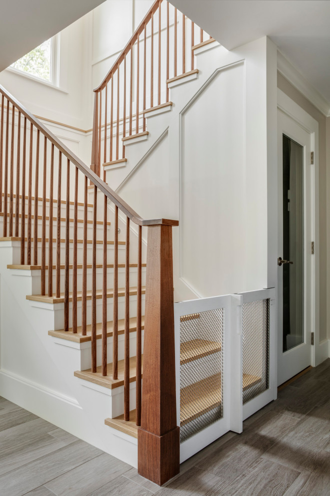 Photo of a medium sized coastal wood l-shaped wood railing staircase in Boston with wood risers.