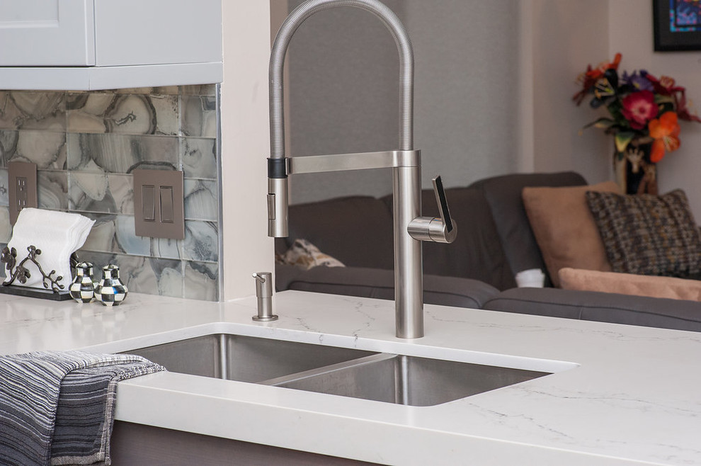 Inspiration for a mid-sized transitional u-shaped porcelain tile and beige floor eat-in kitchen remodel in Miami with an undermount sink, shaker cabinets, gray cabinets, quartz countertops, gray backsplash, glass tile backsplash, stainless steel appliances, white countertops and an island
