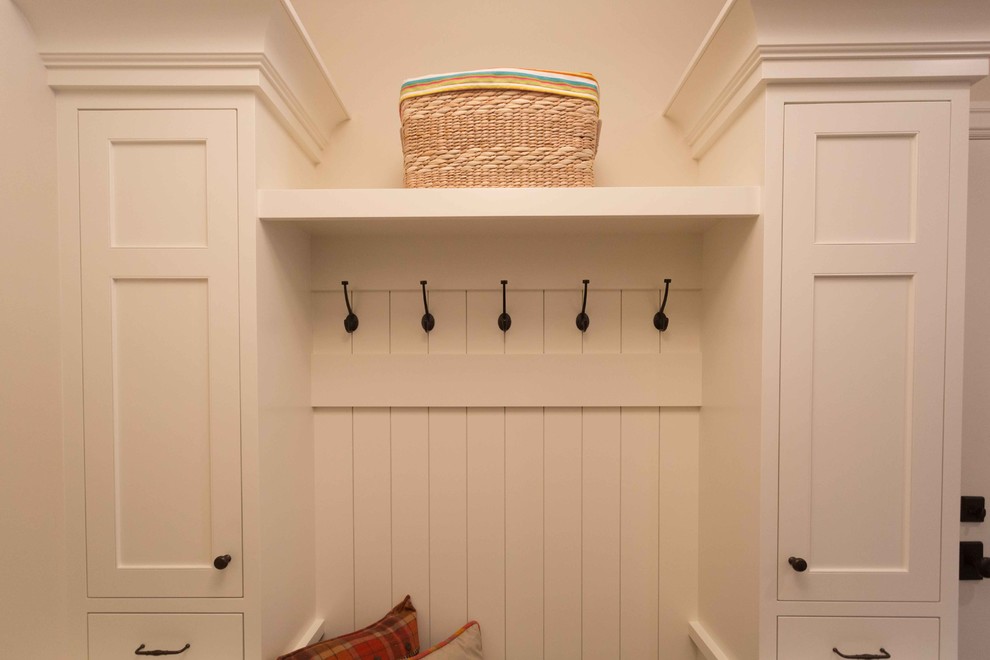 Example of a mid-sized transitional dark wood floor mudroom design in San Diego with beige walls and a white front door