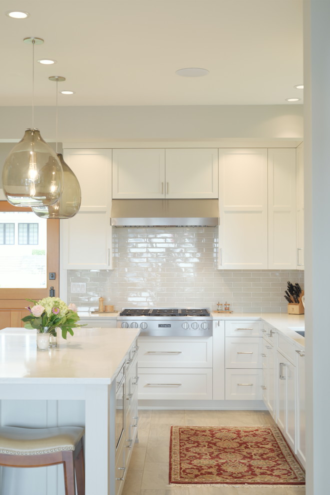 Transitional ceramic tile kitchen photo in Seattle with shaker cabinets, white cabinets, quartzite countertops, subway tile backsplash, stainless steel appliances, an island and white countertops