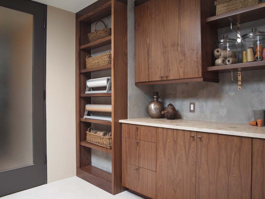 Mid-sized modern single-wall utility room in Chicago with flat-panel cabinets, limestone benchtops, dark wood cabinets and beige walls.
