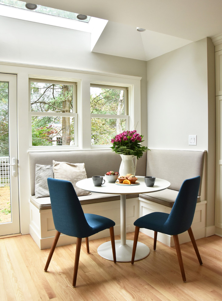 Transitional dining room in Boston with light hardwood floors, grey walls and beige floor.
