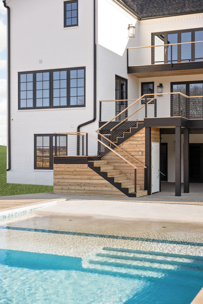 Idee per una grande piscina naturale moderna rettangolare dietro casa con lastre di cemento