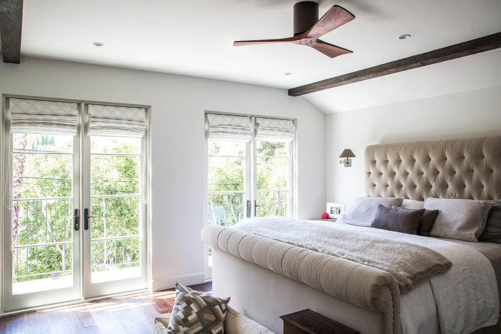 Photo of a transitional bedroom in Los Angeles with white walls and medium hardwood floors.