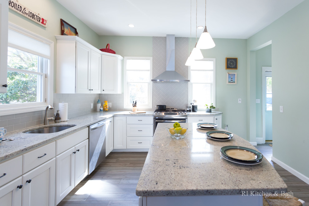 Large transitional l-shaped porcelain tile eat-in kitchen photo in Providence with an undermount sink, recessed-panel cabinets, white cabinets, granite countertops, gray backsplash, ceramic backsplash, stainless steel appliances, green walls and an island