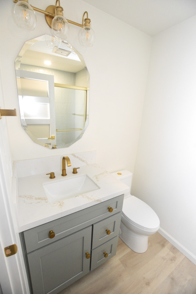 Example of a small transitional master multicolored tile and ceramic tile vinyl floor and single-sink alcove shower design with shaker cabinets, green cabinets, a two-piece toilet, white walls, an undermount sink, quartz countertops, white countertops, a niche and a built-in vanity