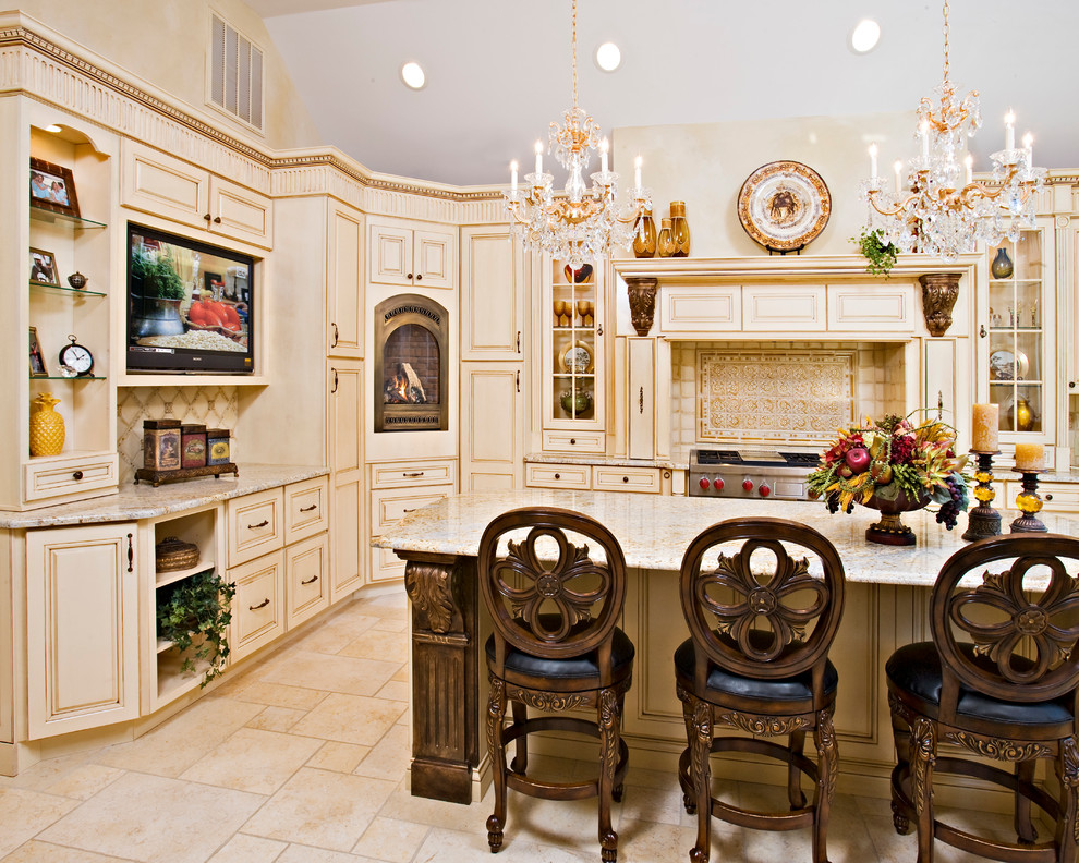 Inspiration for a large traditional u-shaped eat-in kitchen in New York with raised-panel cabinets, beige cabinets, granite benchtops, beige splashback, stone tile splashback, stainless steel appliances, travertine floors, with island, an undermount sink and beige floor.