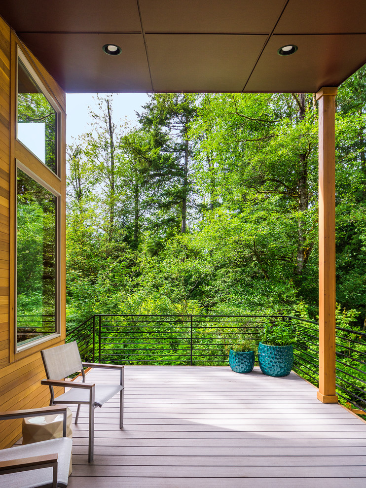 Inspiration for a contemporary backyard deck in Seattle with a roof extension.