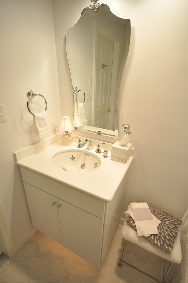 Design ideas for a mid-sized modern kids bathroom in Philadelphia with an undermount sink, flat-panel cabinets, white cabinets, marble benchtops, an alcove tub, a shower/bathtub combo, a one-piece toilet, blue tile, ceramic tile, white walls and ceramic floors.
