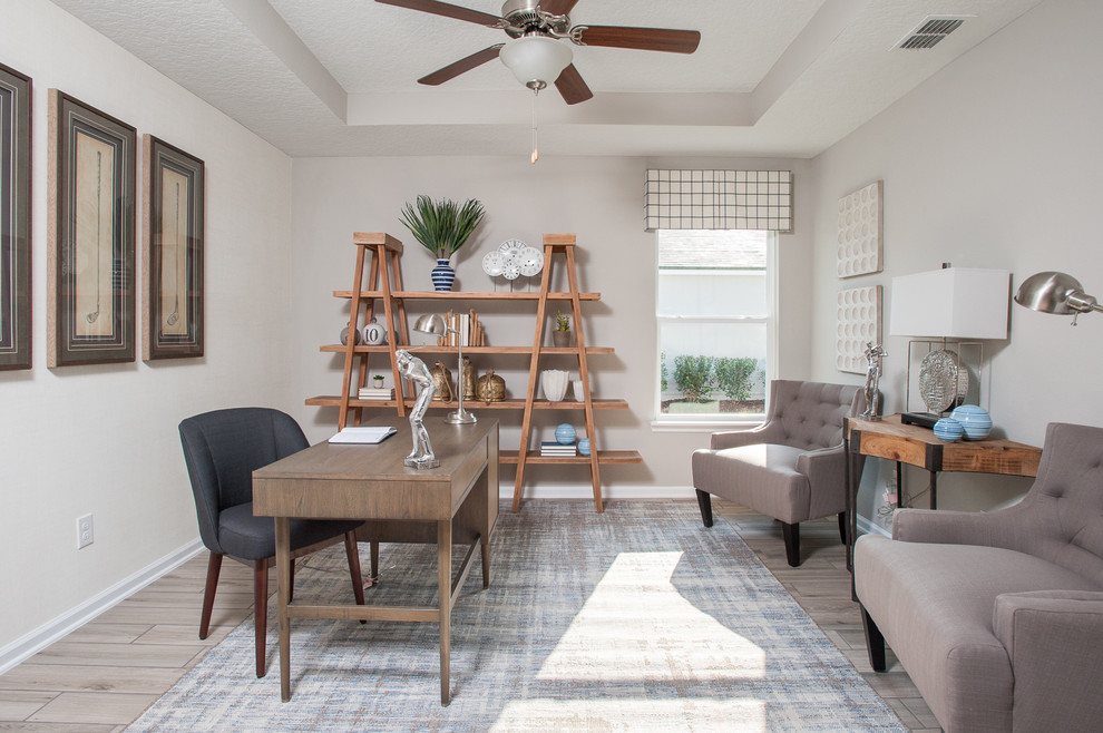 Mid-sized beach style home office in Jacksonville with grey walls, ceramic floors, a freestanding desk and brown floor.