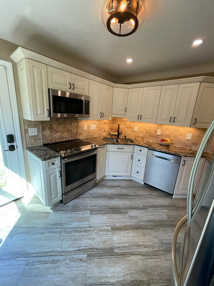 Example of a small transitional u-shaped eat-in kitchen design in Other with an undermount sink, raised-panel cabinets, white cabinets, quartz countertops, beige backsplash, limestone backsplash, stainless steel appliances, no island and multicolored countertops