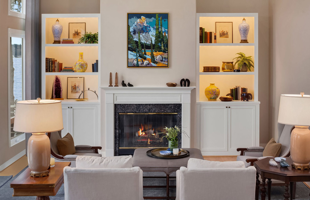 Inspiration for a mid-sized transitional formal enclosed living room in Seattle with beige walls, a standard fireplace, a concrete fireplace surround, no tv, light hardwood floors and beige floor.