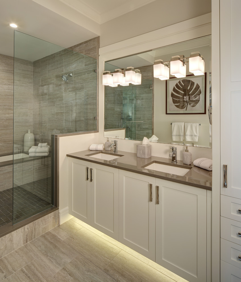 Design ideas for a mid-sized transitional master bathroom in Cleveland with shaker cabinets, white cabinets, an alcove shower, beige tile, porcelain tile, white walls, porcelain floors, engineered quartz benchtops, beige floor, a hinged shower door and grey benchtops.