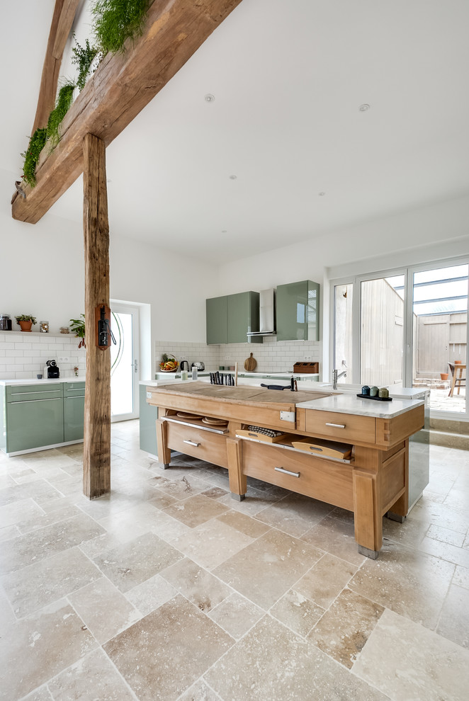 This is an example of a large eclectic l-shaped open plan kitchen in Paris with an undermount sink, flat-panel cabinets, green cabinets, laminate benchtops, white splashback, subway tile splashback, panelled appliances, marble floors, with island and beige floor.