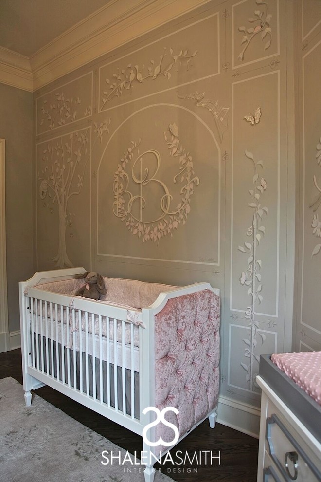 This is an example of a transitional nursery for girls in Nashville with grey walls and dark hardwood floors.