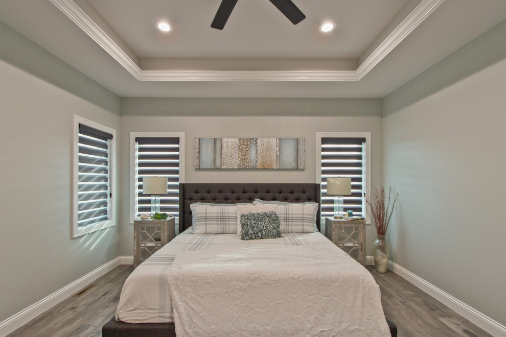 This is an example of a bedroom in Other with beige walls, medium hardwood floors, grey floor and coffered.