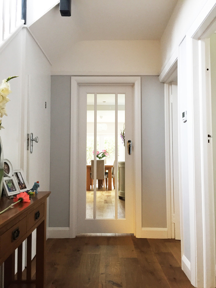 Photo of a traditional entryway in London with a single front door and a dark wood front door.