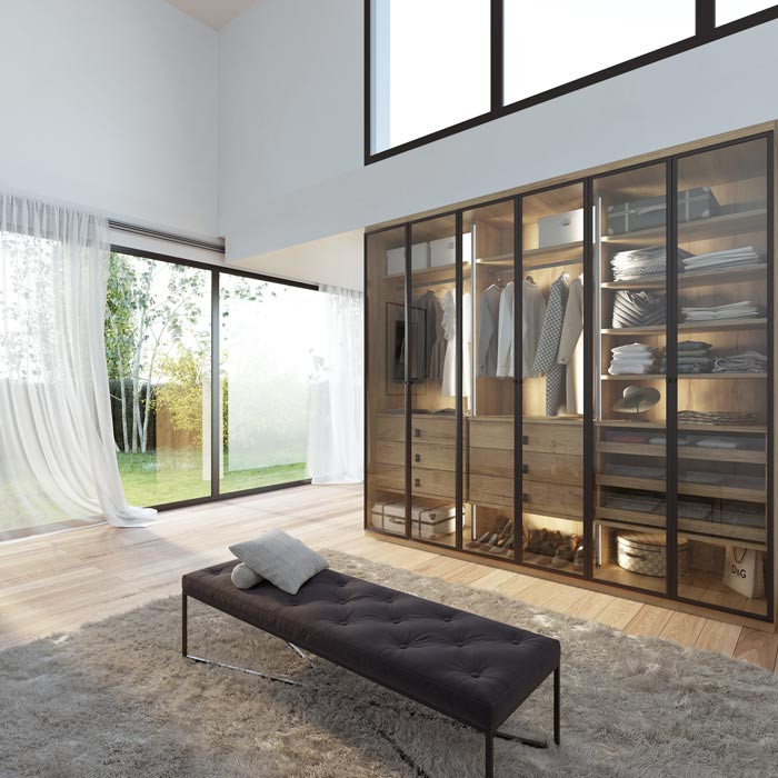 Photo of a contemporary walk-in wardrobe in Paris with glass-front cabinets, brown cabinets and painted wood floors.