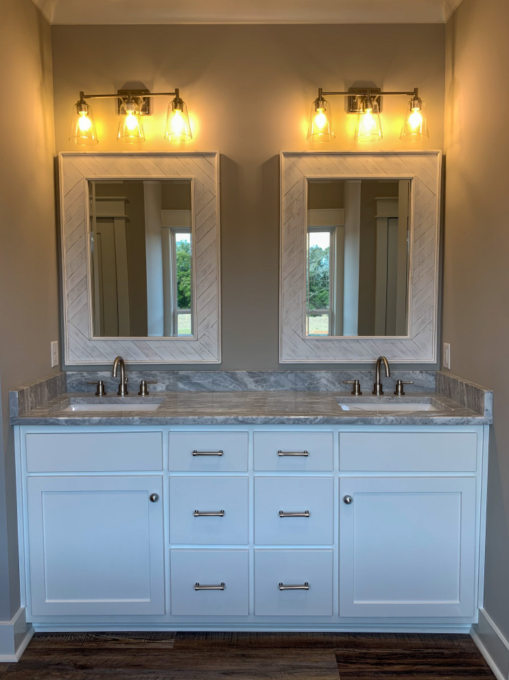 Example of a mid-sized arts and crafts master white tile and marble tile vinyl floor, multicolored floor and double-sink bathroom design in Other with shaker cabinets, white cabinets, a one-piece toilet, gray walls, an undermount sink, marble countertops, gray countertops, a niche and a built-in vanity