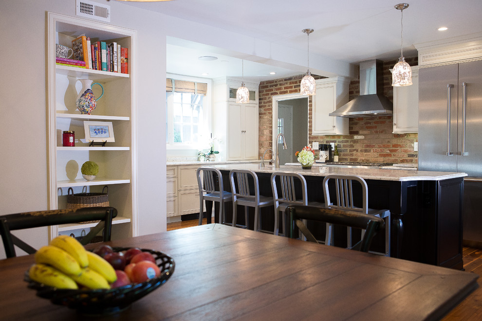 Example of a large transitional medium tone wood floor eat-in kitchen design with an undermount sink, recessed-panel cabinets, black cabinets, quartz countertops, brick backsplash, stainless steel appliances and an island