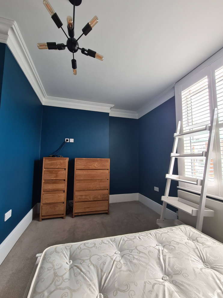Large elegant master carpeted, beige floor and tray ceiling bedroom photo in London with blue walls