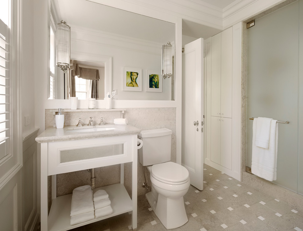 Design ideas for a mid-sized traditional 3/4 bathroom in Chicago with an undermount sink, open cabinets, white cabinets, an alcove shower, a two-piece toilet, grey walls, porcelain floors, multi-coloured floor, gray tile, limestone, limestone benchtops, a hinged shower door, grey benchtops, a single vanity, a freestanding vanity and recessed.