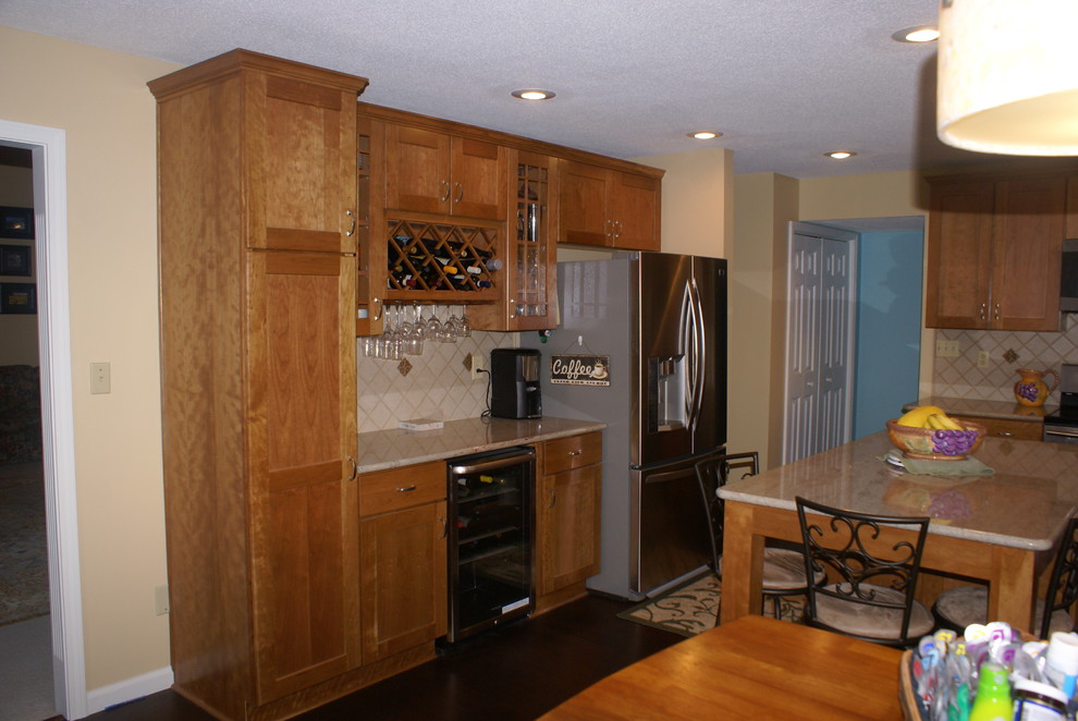 Inspiration for a transitional l-shaped eat-in kitchen remodel in Indianapolis with an undermount sink, recessed-panel cabinets, light wood cabinets, granite countertops and stainless steel appliances