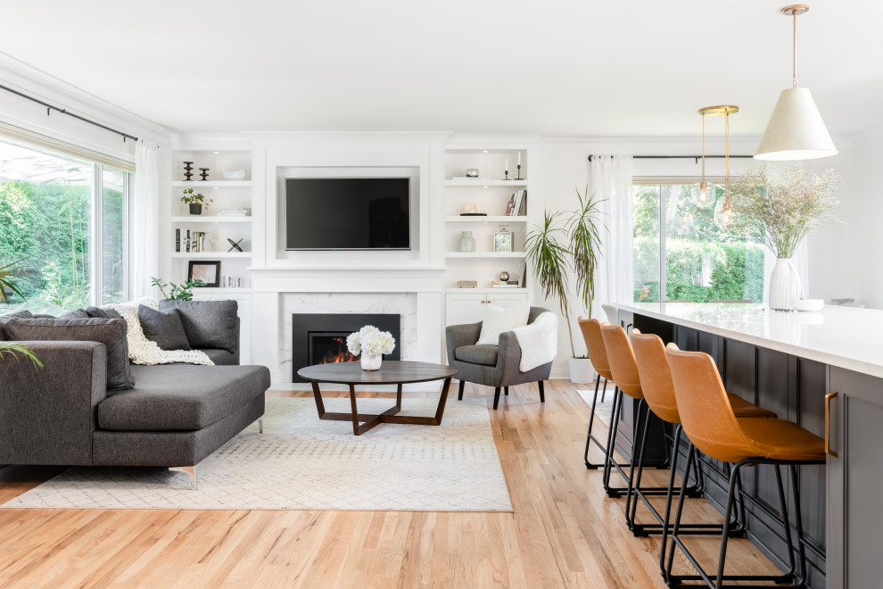 This is an example of a mid-sized transitional formal open concept living room in Vancouver with white walls, light hardwood floors, a tile fireplace surround, a built-in media wall and beige floor.