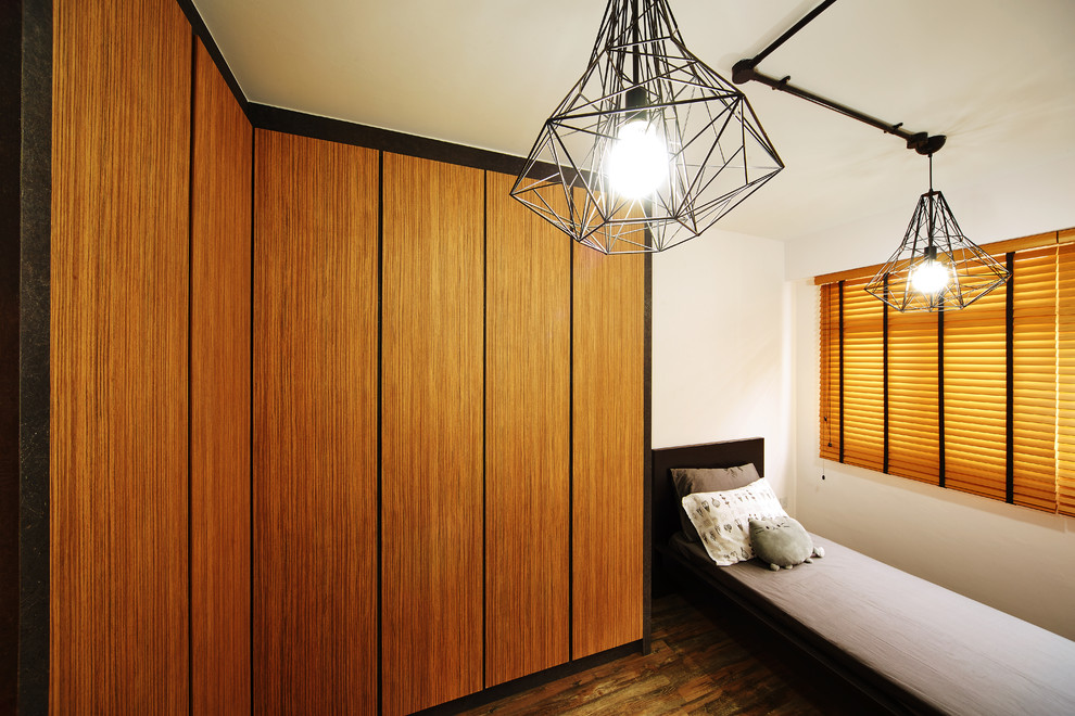 Photo of a small industrial guest bedroom in Singapore with white walls, dark hardwood floors and no fireplace.