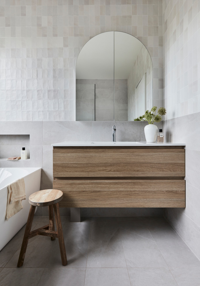 Design ideas for a medium sized nautical family bathroom in Sydney with freestanding cabinets, medium wood cabinets, a corner bath, a corner shower, a one-piece toilet, grey tiles, mosaic tiles, grey walls, porcelain flooring, solid surface worktops, grey floors, a hinged door, white worktops, a single sink and a floating vanity unit.