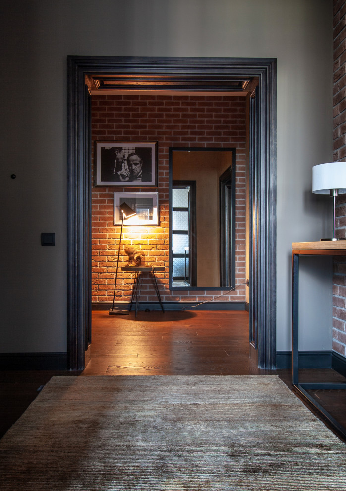 Photo of a contemporary entryway in Moscow with dark hardwood floors.