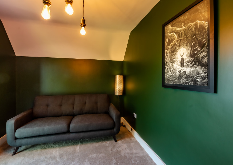 Medium sized urban study in Kent with green walls, carpet, a freestanding desk, grey floors and feature lighting.