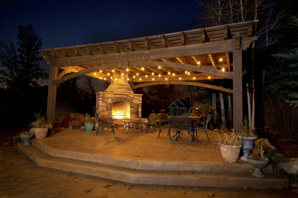Photo of a mid-sized arts and crafts backyard patio in Salt Lake City with a pergola, with fireplace and concrete slab.