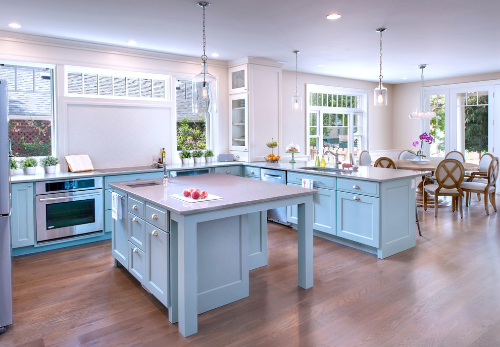 Inspiration for a beach style kitchen in Denver with flat-panel cabinets and blue cabinets.